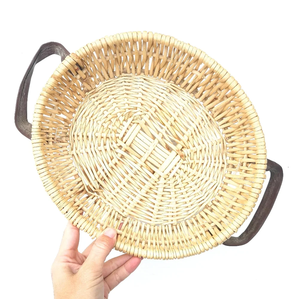 Woven wicker basket with faux leather handles